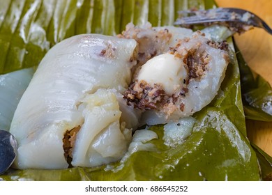 Top view of a traditional food in Vietnam call Banh Gio or pyramid shaped. Make from rice flour dumpling filled with pork , shallot and mushrooms , wrapped in banana leaf. Delicious street food.
