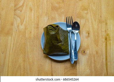 Top view of a traditional food in Vietnam call Banh Gio or pyramid shaped. Make from rice flour dumpling filled with pork , shallot and mushrooms , wrapped in banana leaf. Delicious street food.