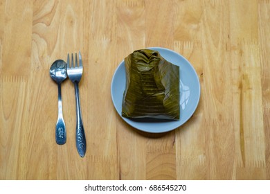 Top view of a traditional food in Vietnam call Banh Gio or pyramid shaped. Make from rice flour dumpling filled with pork , shallot and mushrooms , wrapped in banana leaf. Delicious street food.