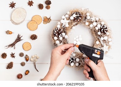 Top View Of Traditional Handmade Diy Christmas Wreath Made With Natural Elements And Hot Glue Gun. Winter Holidays And Christmas Celebration Concept