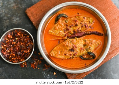 Top View Of Traditional Sri Lankan Fish Curry King Fish Curry, Sri Lanka On Dark Or Black Background. Hot And Spicy Homemade Yellow Fish Curry Made Using Coconut Milk , Gambooge, Turmeric.