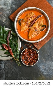 Top View Of Traditional Sri Lankan Fish Curry King Fish Curry, Sri Lanka On White Background. Hot And Spicy Homemade Yellow Fish Curry With Gravy Made Using Coconut Milk , Gambooge, Turmeric.