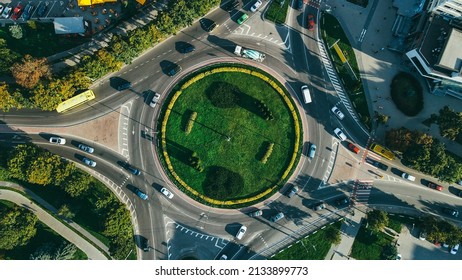 Top View Of Traffic And People, Cars And Buses At Rush Hour At Circular Junction