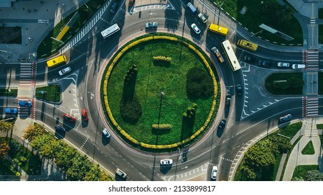 Top View Of Traffic And People, Cars And Buses At Rush Hour At Circular Junction