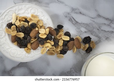 A Top View Of A Trail Mix In A White Plate On A Marble Table