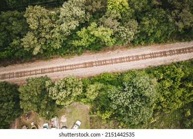 A Top View Of A Train Track In A Forest