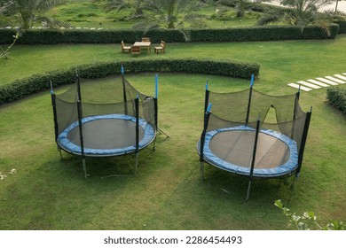Top view of trampoline on green yard at park in summer - Shutterstock ID 2286454493