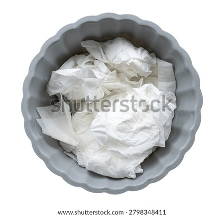 Top view of trash bin filled with used tissues and paper waste isolated on white background