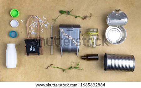 top view of trash bins and assorted garbage as paper, plastic, glass, metal, microgreen, recycle concept, save the nature