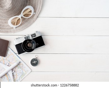 Top View Travel Concept With Retro Camera Films, Map, Passport, Smartphone On White Table Background With Copy Space, Tourist Essentials, Vintage Tone Effect