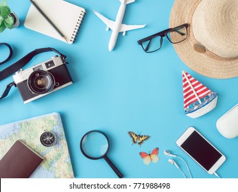 Top View Travel Concept With Retro Camera Films, Smartphone, Map, Passport And Outfit Of Traveler On Blue Background With Copy Space, Tourist Essentials, Vintage Tone Effect