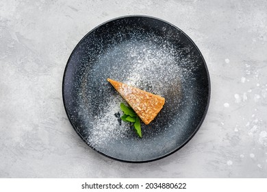 Top View Of Triangular Piece Of Caramel Cheese Cake On A Plate