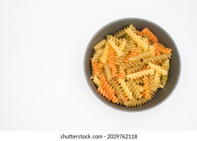 A Top View Of Tri-color Rotini Pasta On A Bowl Isolated On White Background