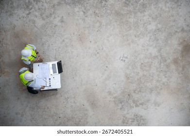 Top view of two architects are drafting the building's structural plans and planning construction