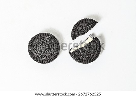 Top view of two biscuits with vanilla flavor isolated on a white white background. cookies. black. sandwich. vanila. cream. clipping path. Broken. High angle. Above. Close up. Cracked. Crack. Filled.
