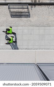 Top View Of Two Cops Patrolling City Streets Wearing Black Uniforms And Vests