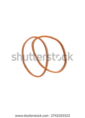 Top view of two interlinked orange rubber bands for office and household use, isolated on white background