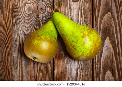Top view of two pears on a dark wooden background. Organic foods, healthy nutrition.