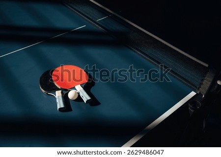 Top view. Two rackets and ball on the tennis table.