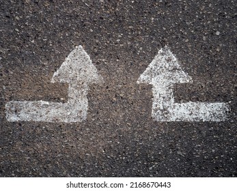 Top View Of Two White Arrows Pointing Up In The Asphalt Of A Road. Concept Of Guidance, Lead And Moving Forward