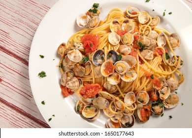 Top View Of Typical And Delicious Spaghetti With Clams On A Table Of A Classic Italian Tavern.