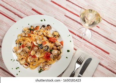 Top View Of Typical And Delicious Spaghetti With Clams On A Table Of A Classic Italian Tavern.