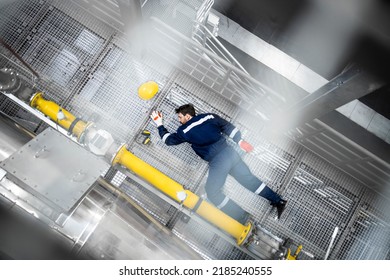 Top View Of Unconscious Factory Worker Lying Down In Production Plant. Injury At Work.