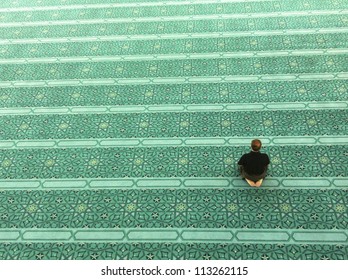 Top view of an unidentified Muslim man prays in a mosque - Powered by Shutterstock