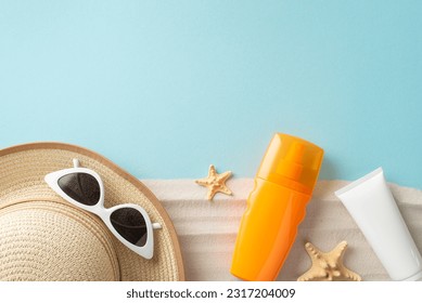 Top view of unlabeled SPF cream bottles, alongside sunglasses, sunhat, starfishes, set against a pastel blue and sandy backdrop with an empty space for branding or promotion - Powered by Shutterstock