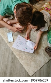 Top View Of Unrecognizable Kids Playing Treasure Hunt At Home On The Carpet