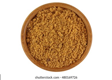 Top view of unrefined unbleached natural Brown sugar in brown color in a wooden bowl isolated on white background