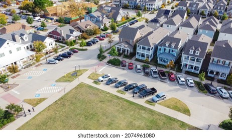Top view upscale residential neighborhood with under construction wooden houses near historic Old Town Coppell, Texas, USA. Cottage style homes with covered porch patio, no backyard