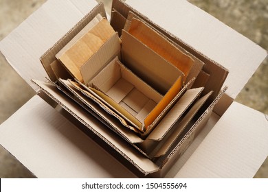 Top View Of Used Shipping Cardboard Boxes In Multiple Sizes Stacked On Each Other , Awaiting For Reuse ,all Collected From Online Shopping , Recycle Concept 