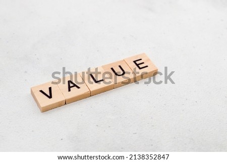 Top view of Value word on wooden cube letter block on white background. Business concept