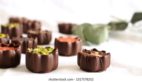 Top view of various chocolate pralines isolated on white background.Exclusive chocolate candies. Product concept for chocolatier.