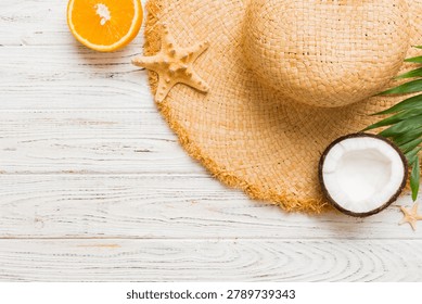 Top view of various seashells placed near colorful fruit and stylish summer accessories on table background. Summer concept. Flat lay. Top view with copy space for text.