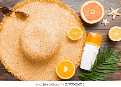 Top view of various seashells placed near colorful fruit and stylish summer accessories on table background. Summer concept. Flat lay. Top view with copy space for text.