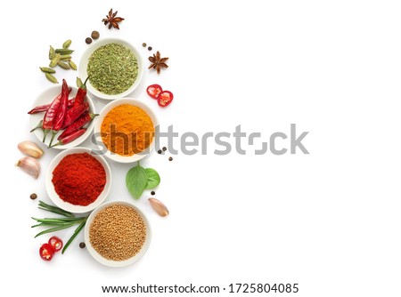 Top view of various spices in bowls isolated on white background. Copy space.