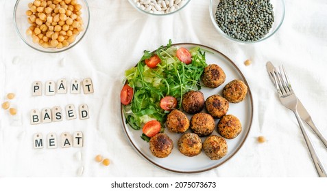 Top View Vegan Veggie Meatballs On The Plate With Fresh Salad. Pea Protein Ingredients On The Background. Plant Based Meat Concept.Vegetarian Lunch. Healthy Eating. Go Vegan. Wide Banner.