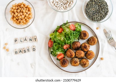 Top View Vegan Veggie Meatballs On The Plate With Fresh Salad. Pea Protein Ingredients On The Background. Plant Based Meat Concept.Vegetarian Lunch. Healthy Eating. Go Vegan. Selective Focus.