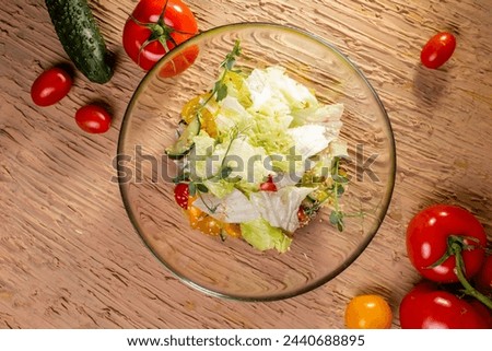 Top view Vegetable Salad Bowl with Tomatoes, Cucumbers, Lettuce, Carrots, Greens
