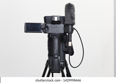 The Top View Of Video Camera With The Microphone Is Standing On The Tripod Isolated On White, In Concept Of Technology, Modern, Entertainment.