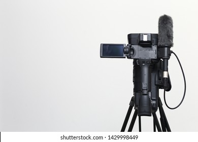 The Top View Of Video Camera With The Microphone Is Standing On The Tripod Isolated On White, In Concept Of Technology, Modern, Entertainment.