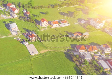 Top view of the village houses with red tiled roof  in the sunlight