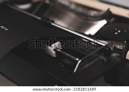 Top view of vintage typewriter with black paper and white ink. Closeup 1970 typewriter.