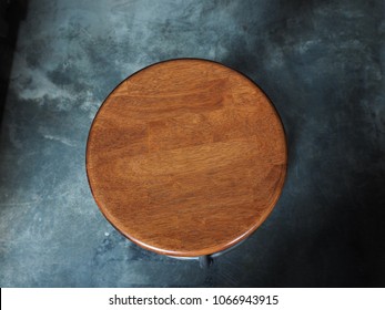 Top view vintage wooden round chair on cement concrete texture floor background.
