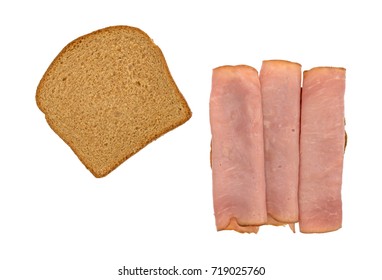 Top View Of A Virginia Ham Sandwich On Wheat Bread Plus A Slice To The Side Isolated On A White Background.