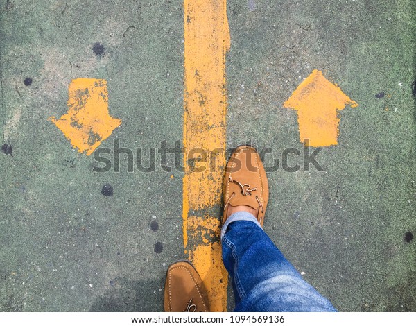 top view walking on street with\
arrow background, leather shoes, traffic sign\
on\
street