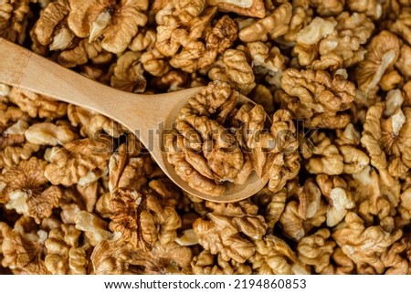Top view wallnut in spoon with group of wallnut