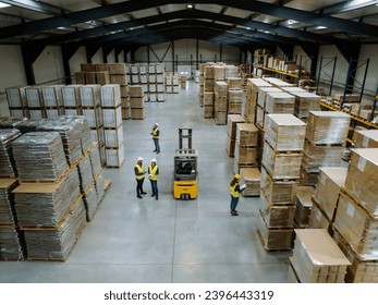 Top view of warehouse workers in warehouse. Team of warehouse workers preparing products for shipment, checking delivery, stock in warehouse. - Powered by Shutterstock